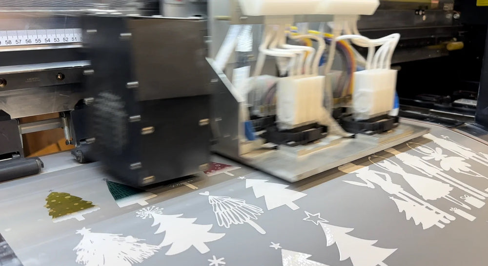 DTF printer applying artwork and white ink to transfer film.
